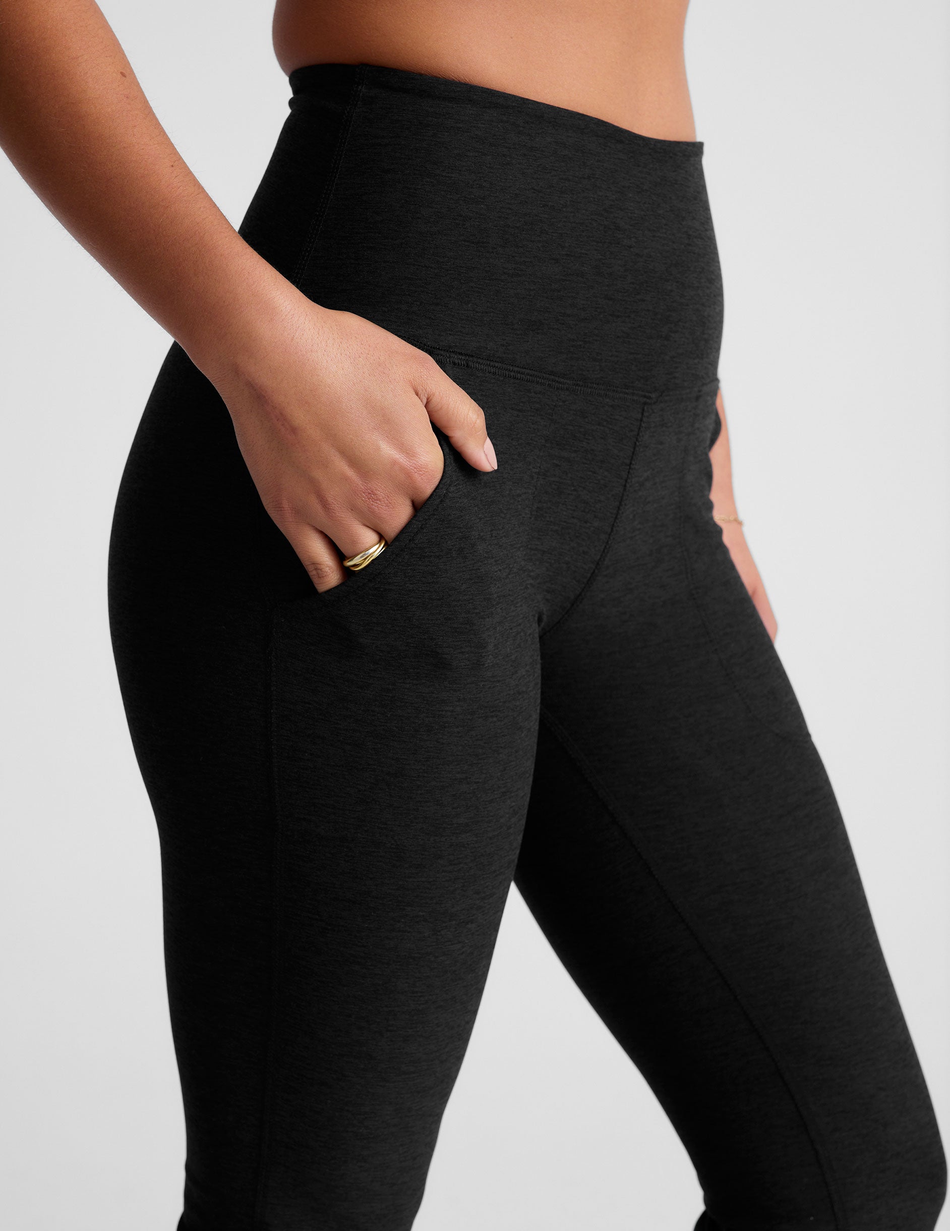black high-waisted bootcut pants with side pockets.