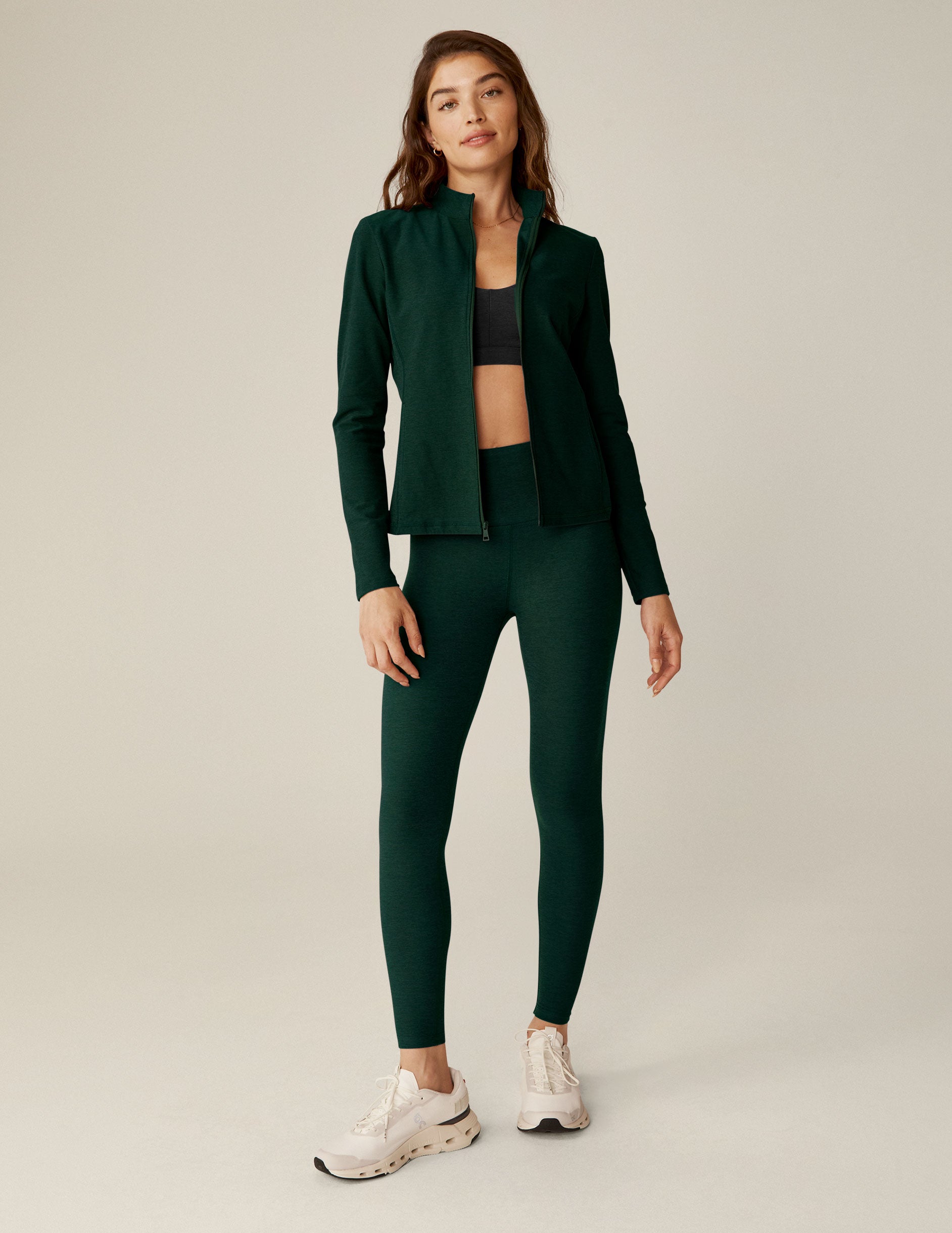 green zip-up mock neck jacket with side pockets.
