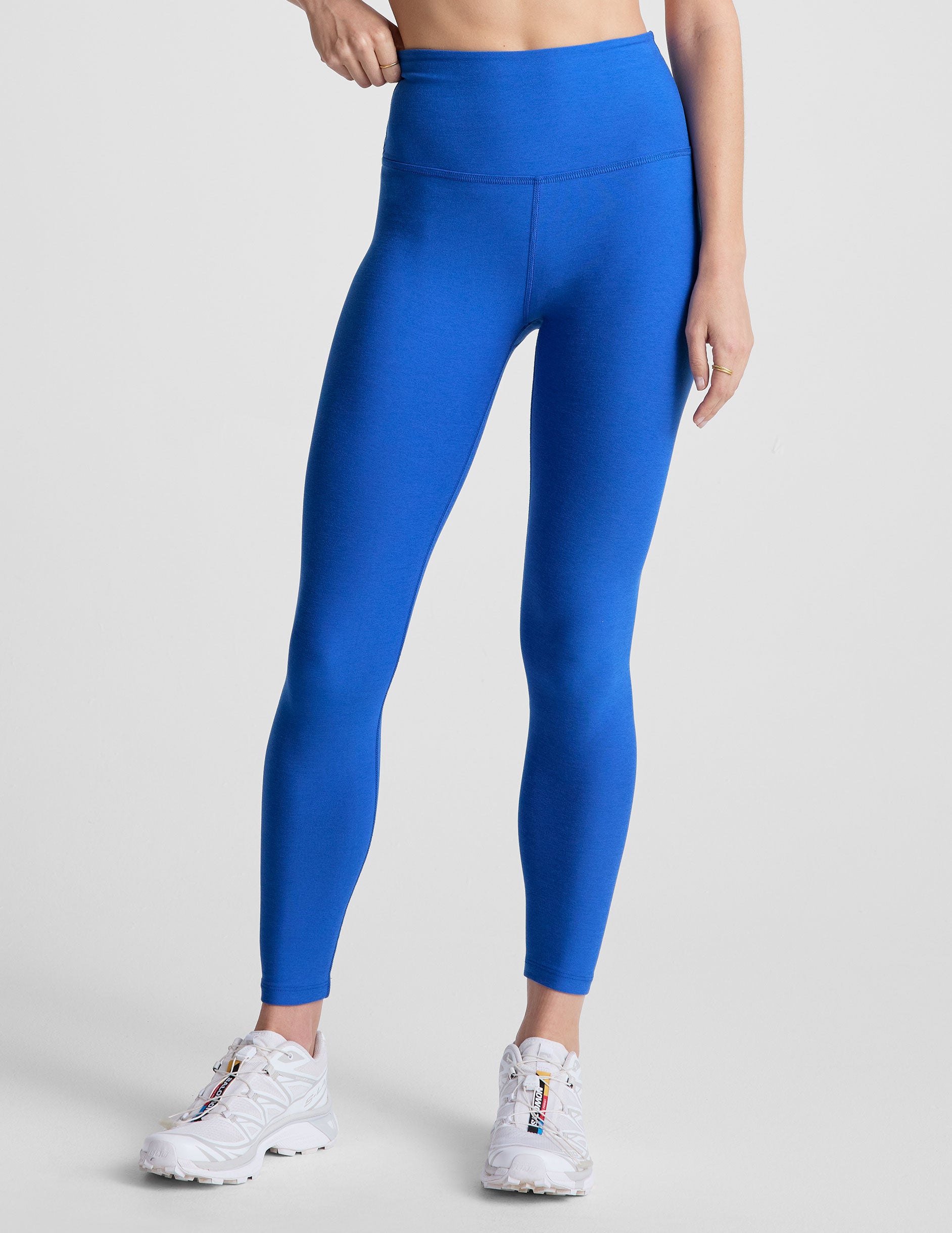 blue high-waisted midi length leggings with a 24" inseam and 5" rise waistband.