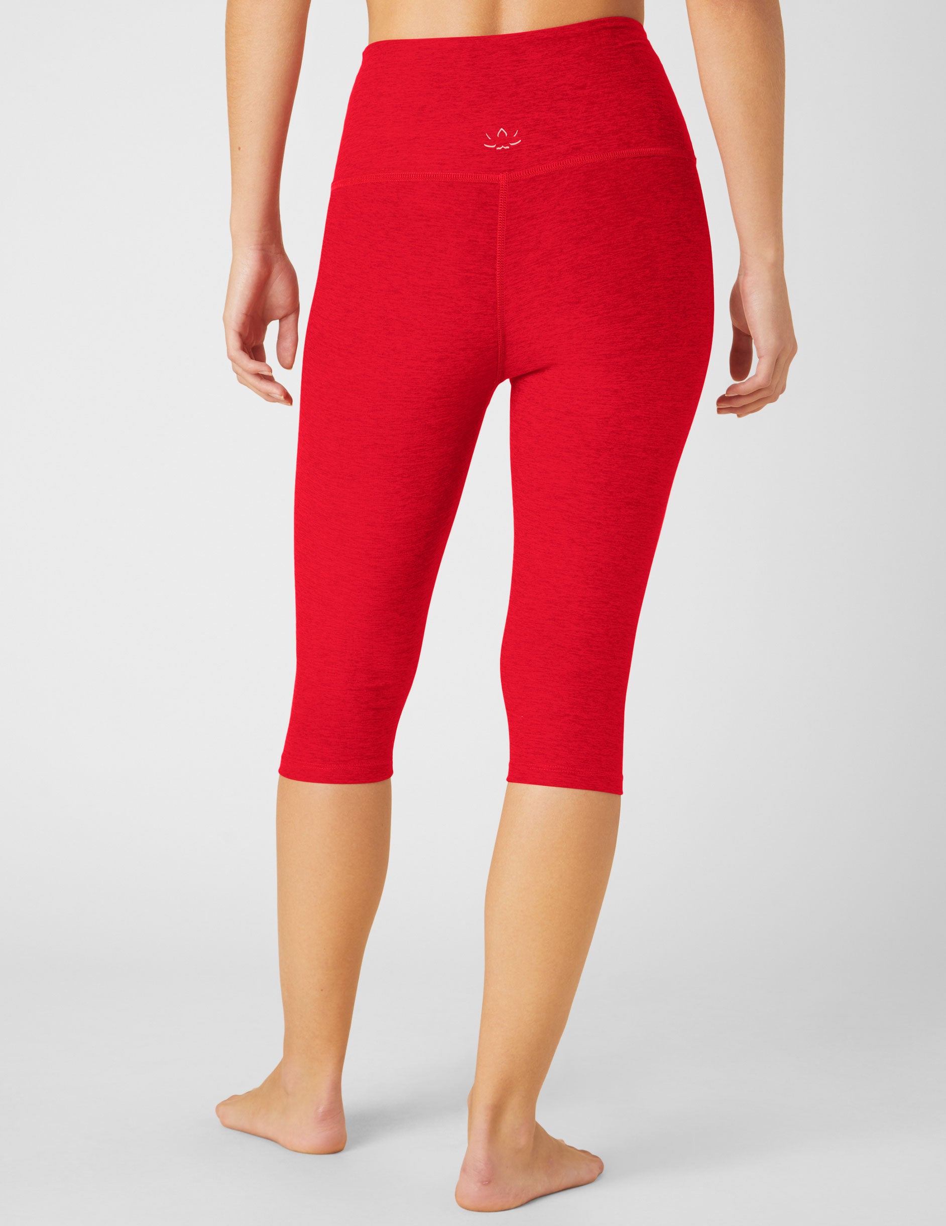 red high-waisted pedal pusher length leggings.
