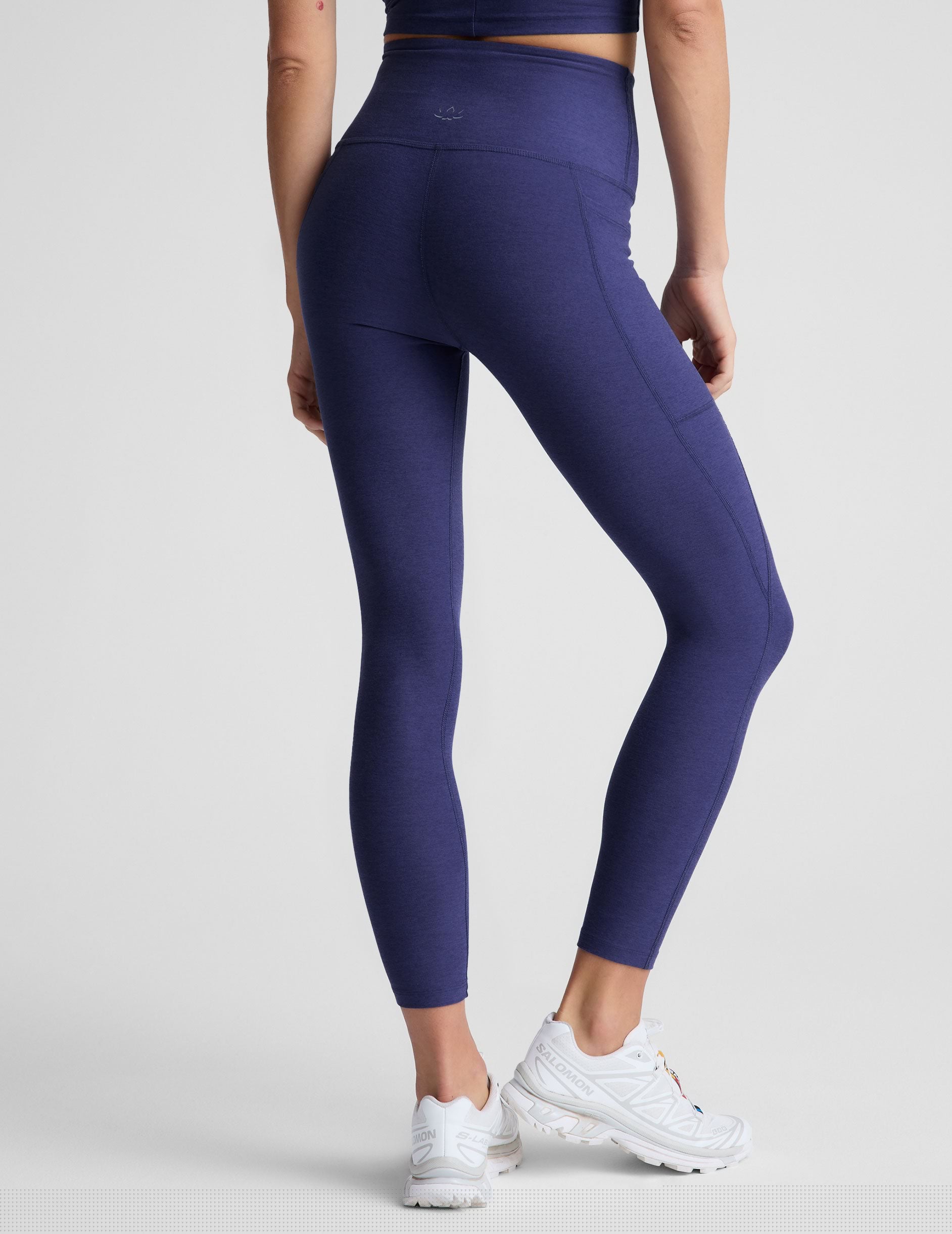 blue midi length high-waisted leggings with side pockets.