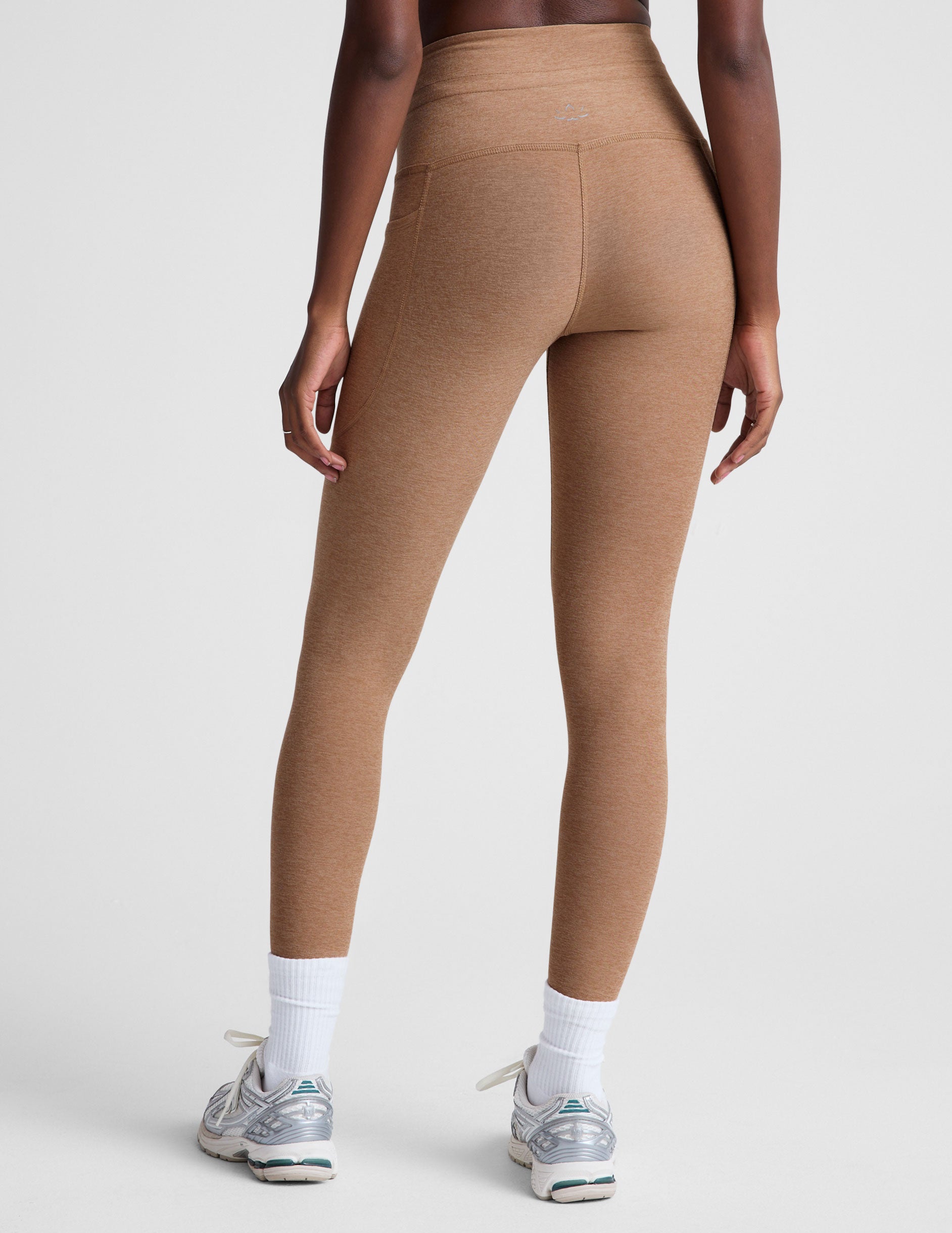 brown high-waisted midi leggings with a drawstring at waistband.