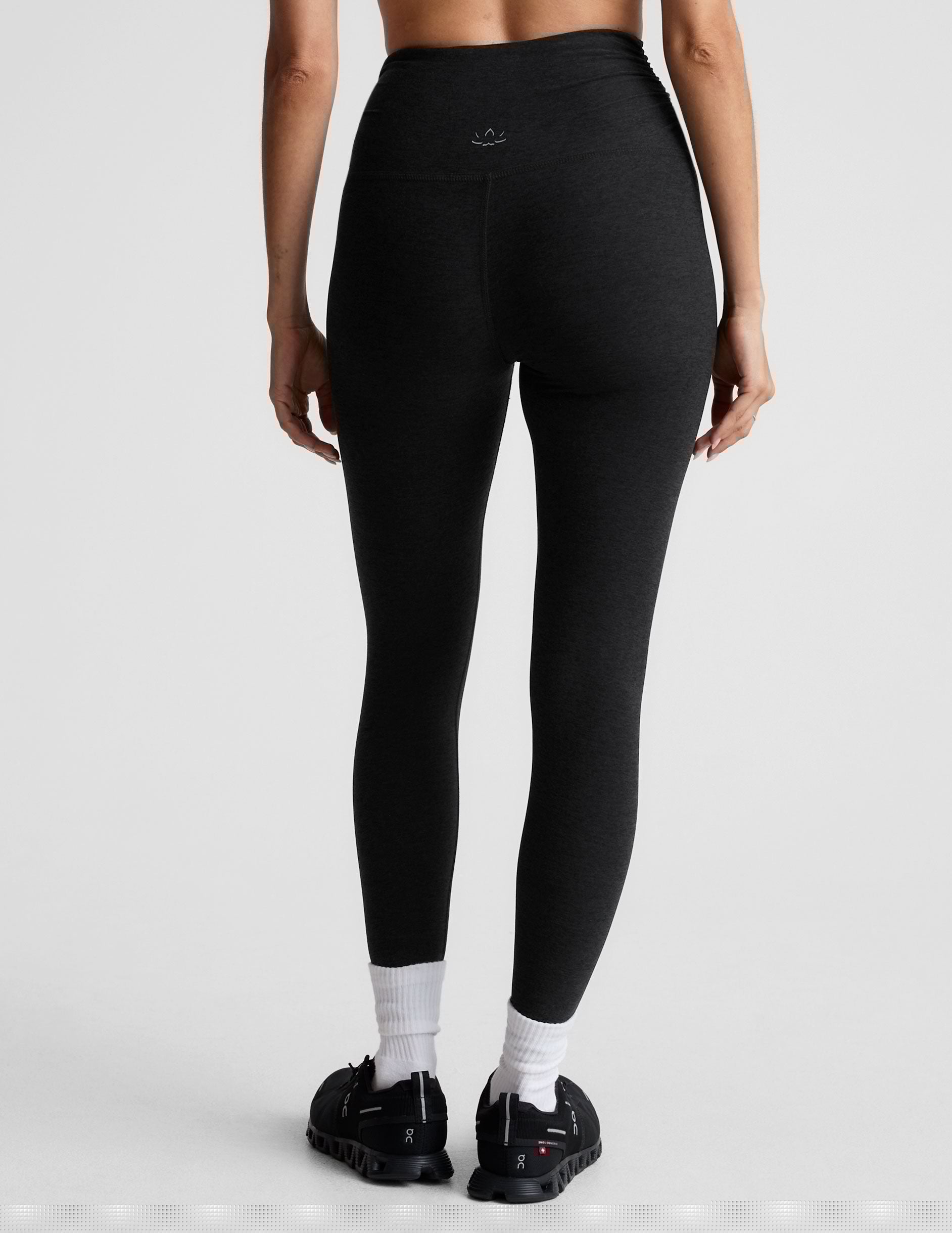 black high-waisted midi length legging with a shirred detail on the sides of the waistband.