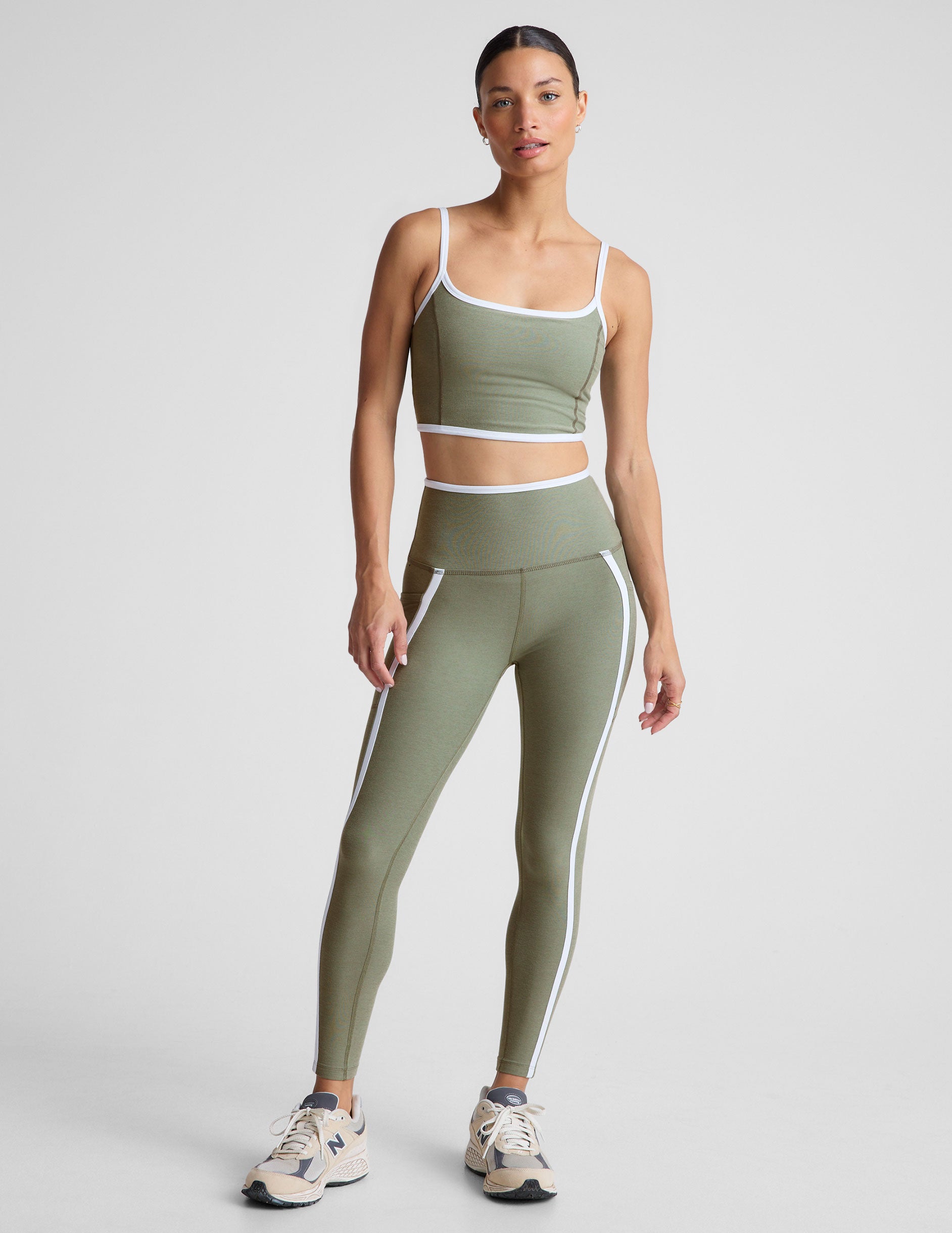 green cropped tank top with contoured princess seams and white piping detail along edges.