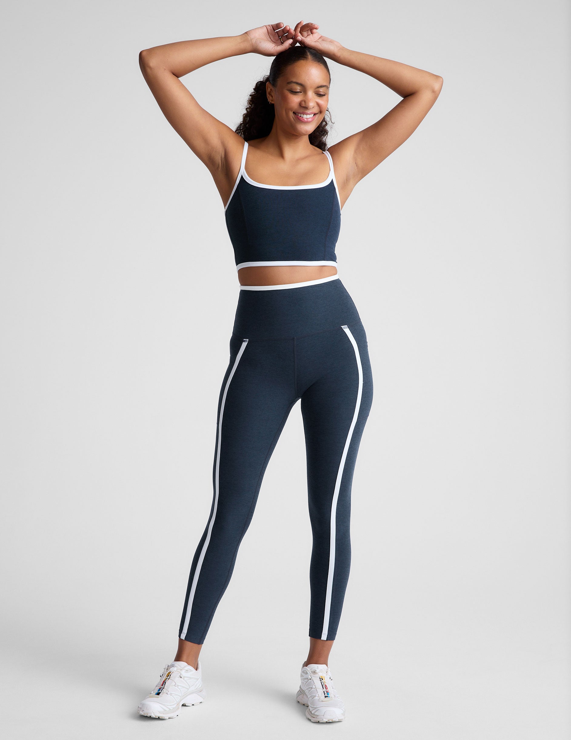 blue cropped tank with princess seams and white piping along edges.