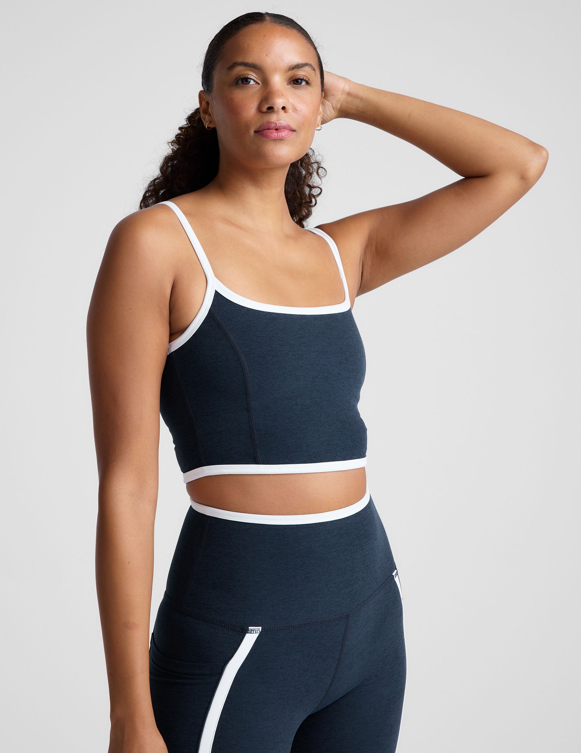 blue cropped tank with princess seams and white piping along edges.