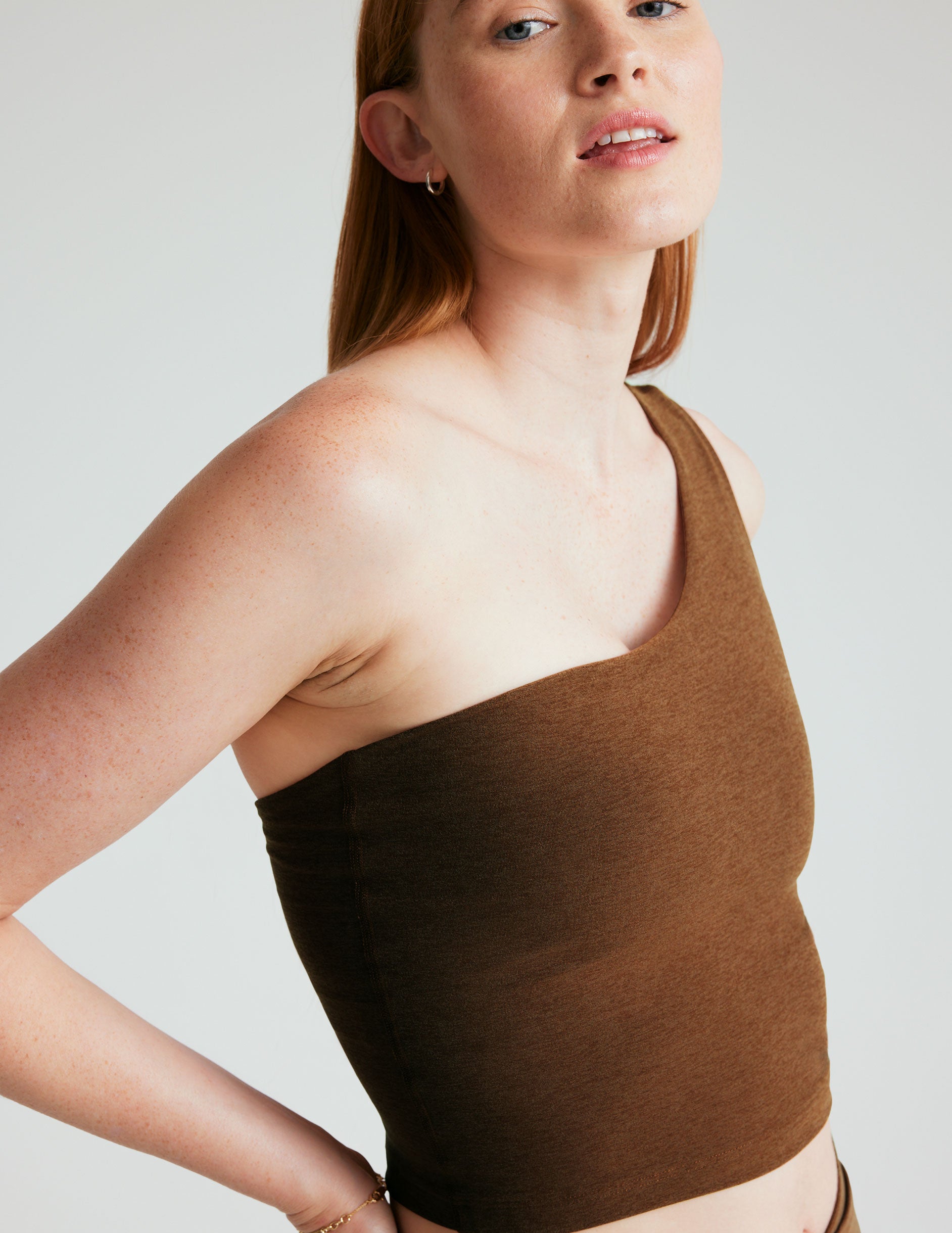 brown one shoulder spacedye cropped tank with a cutout detail on the back strap.