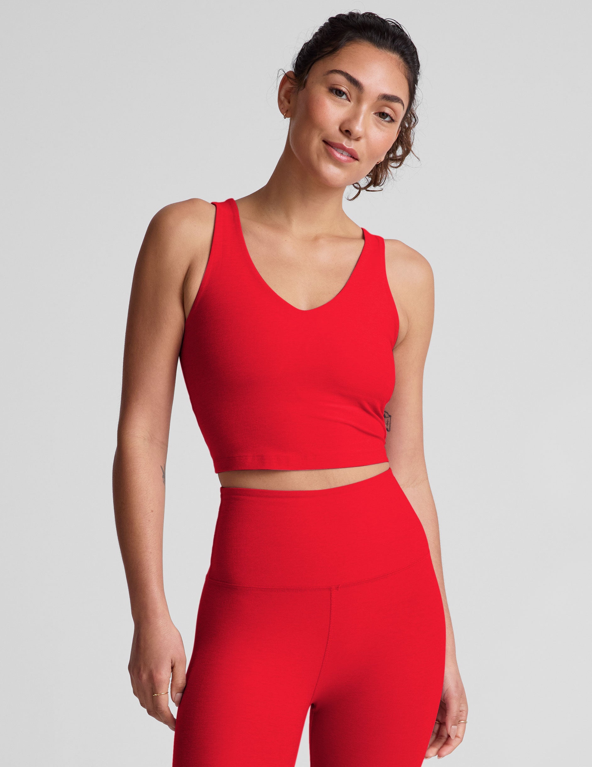 red cropped tank top with a front and back v neckline.