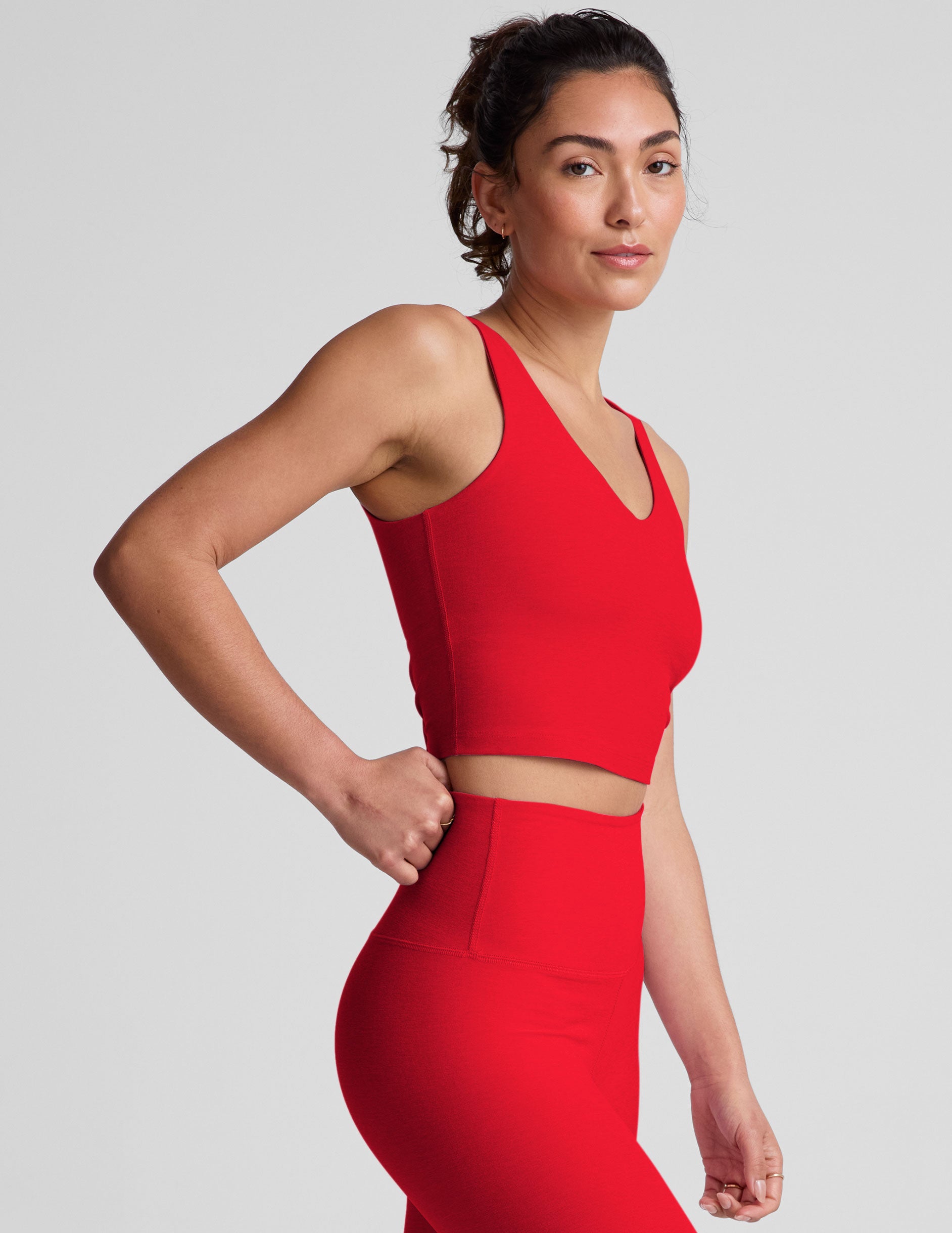red cropped tank top with a front and back v neckline.