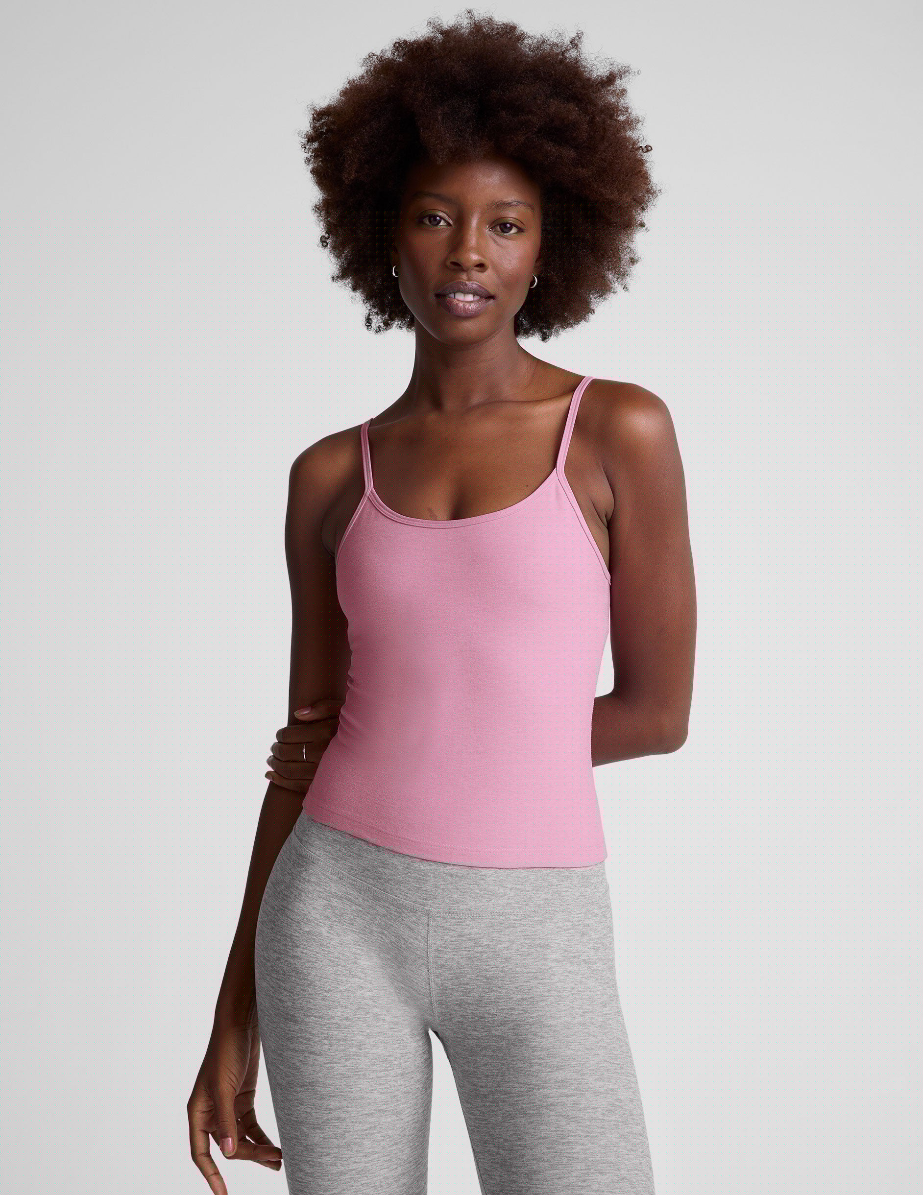 pink waist length tank with adjustable spaghetti straps.