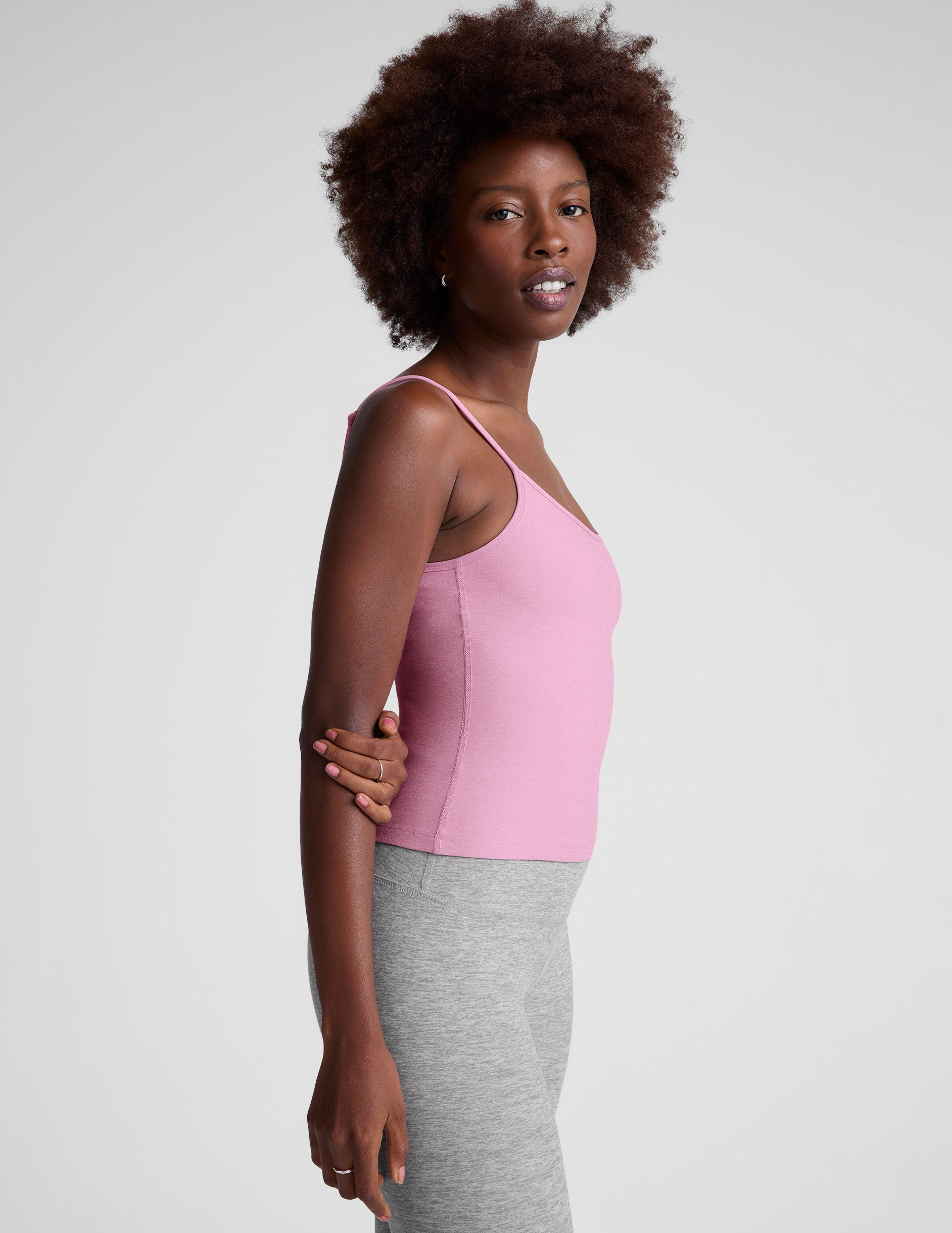pink waist length tank with adjustable spaghetti straps.