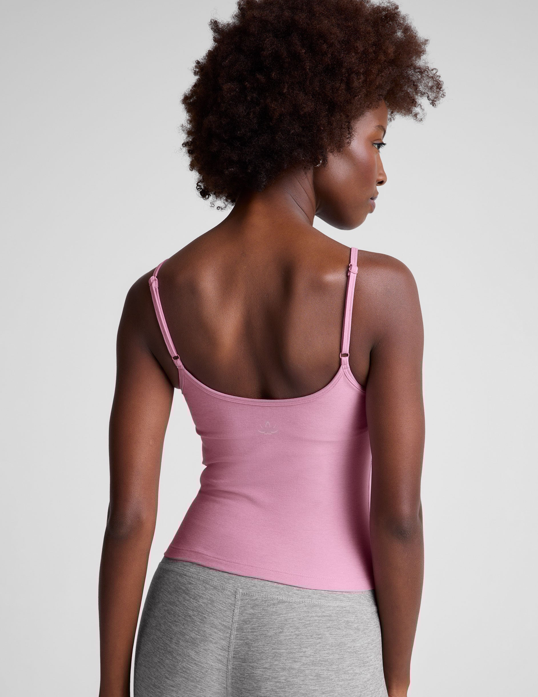 pink waist length tank with adjustable spaghetti straps.