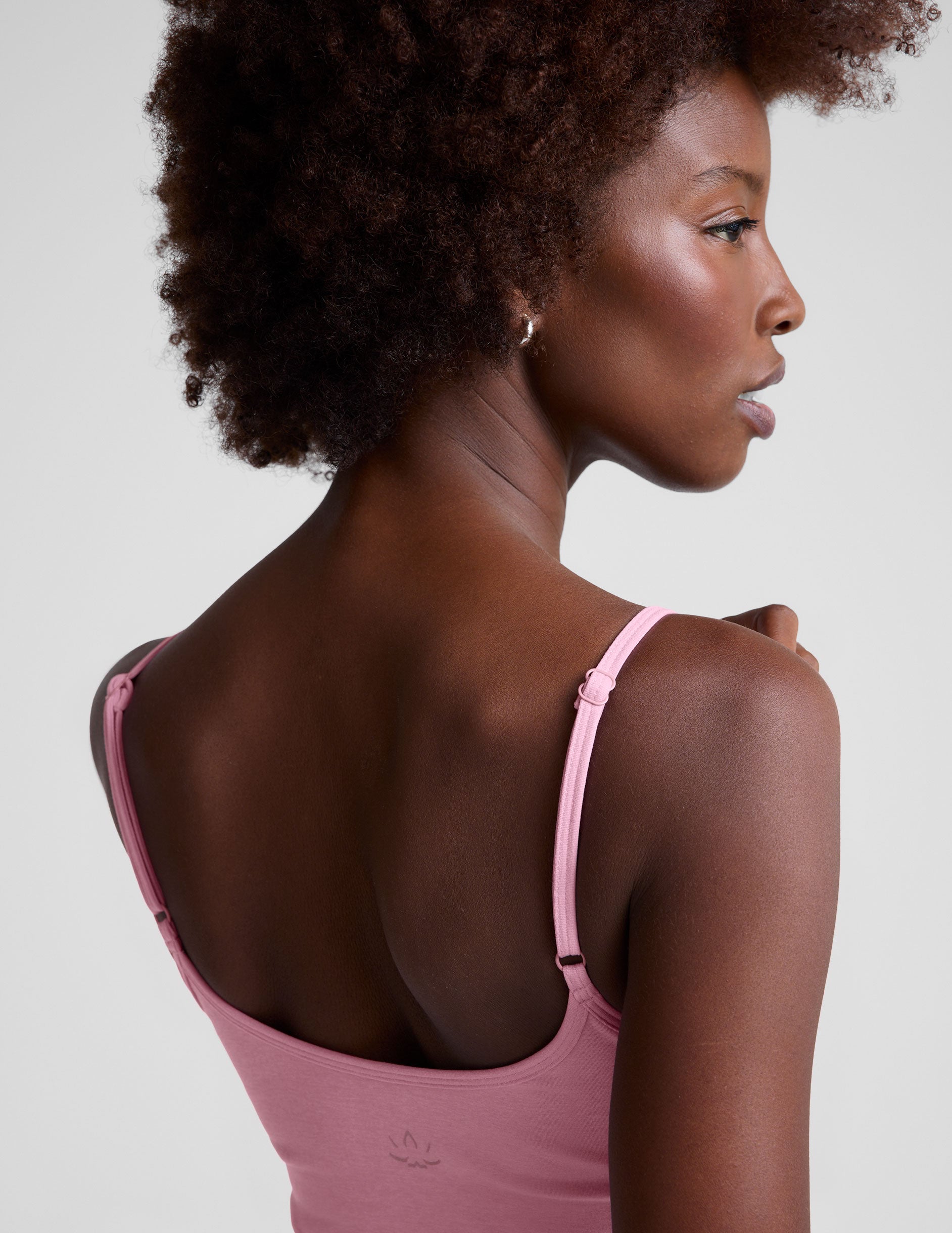 pink waist length tank with adjustable spaghetti straps.