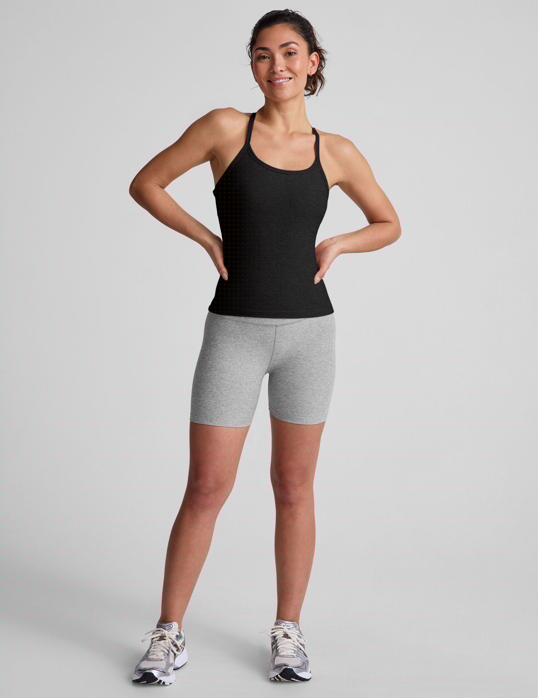 black midway length tank with adjustable spaghetti straps.