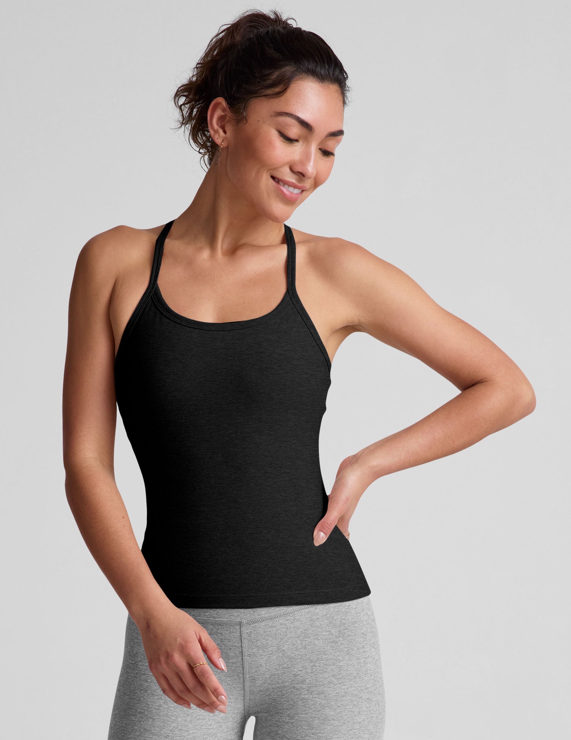 black midway length tank with adjustable spaghetti straps.