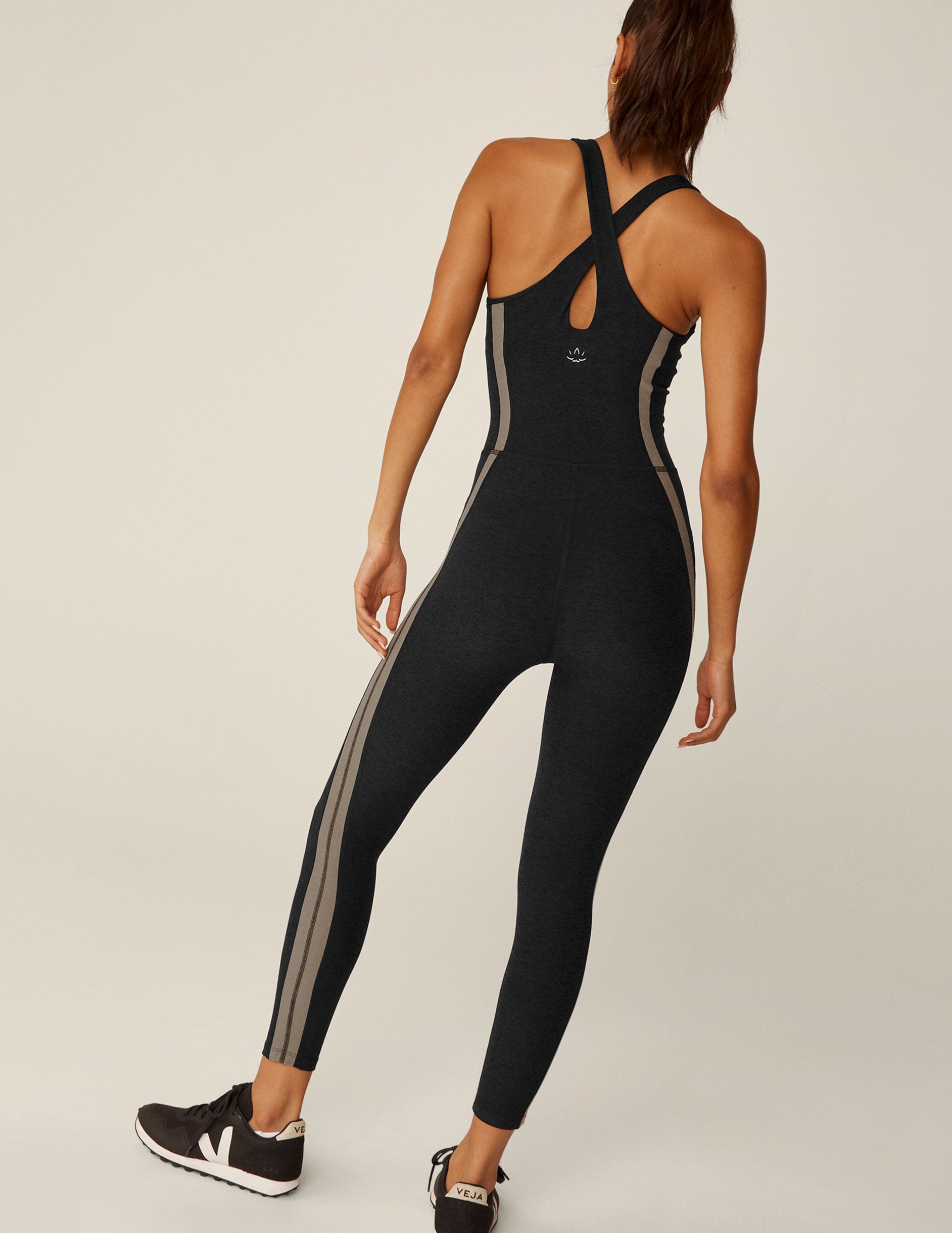 black racerback jumpsuit with brown lining down the sides.