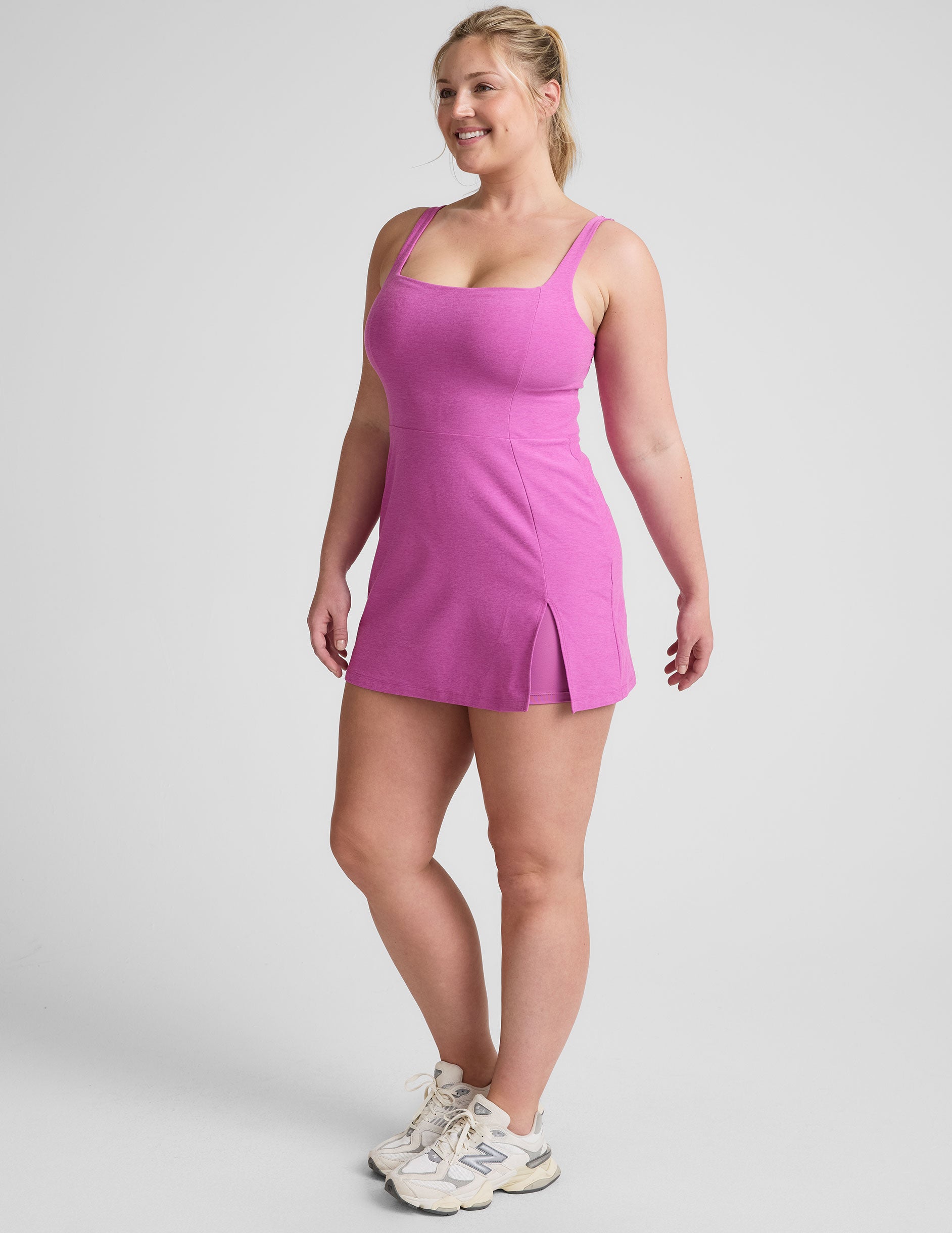 purple mini tank dress with a square neckline, side slit, and built-in shorts with pockets.