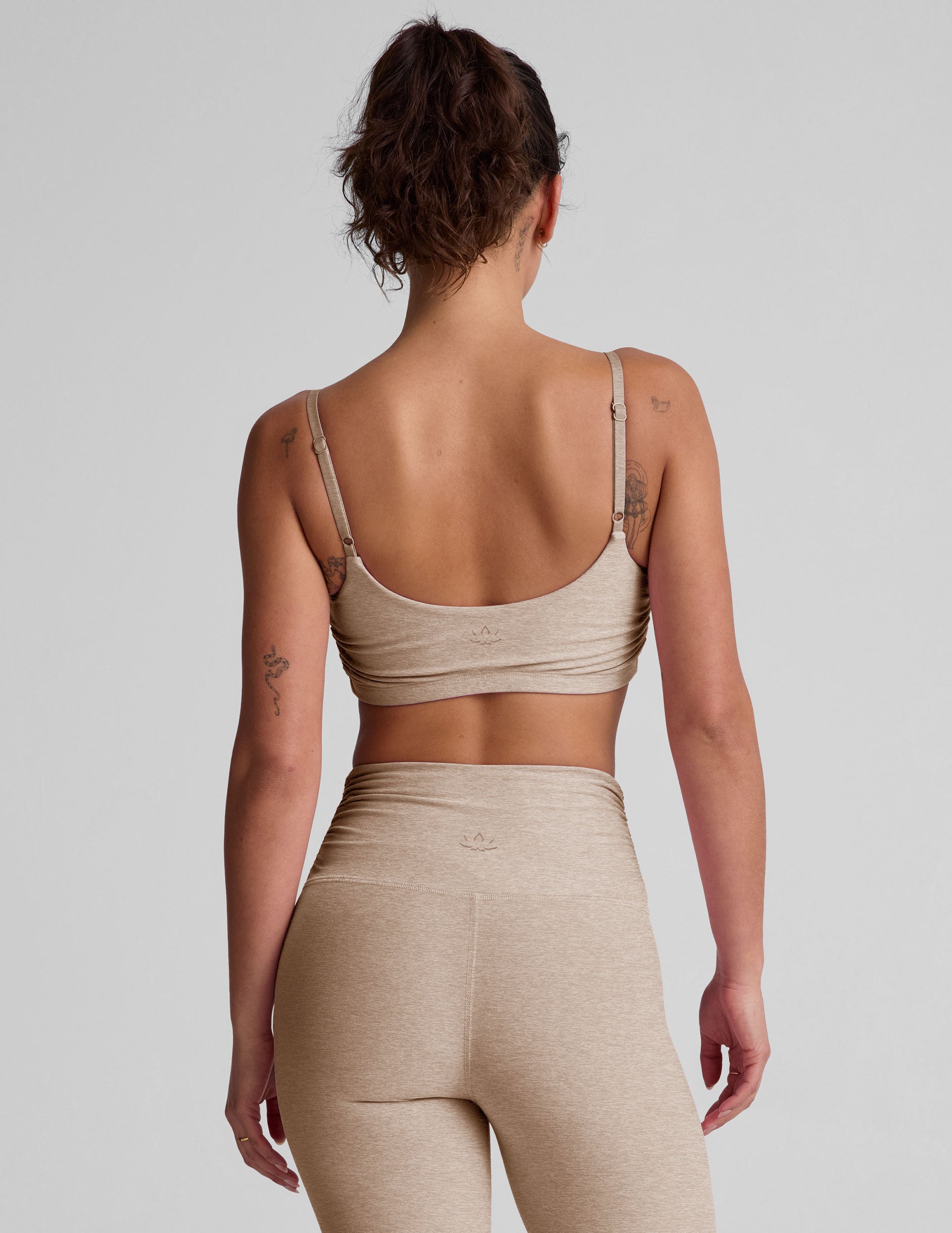 brown bra with shirred detailing on the sides and adjustable straps.