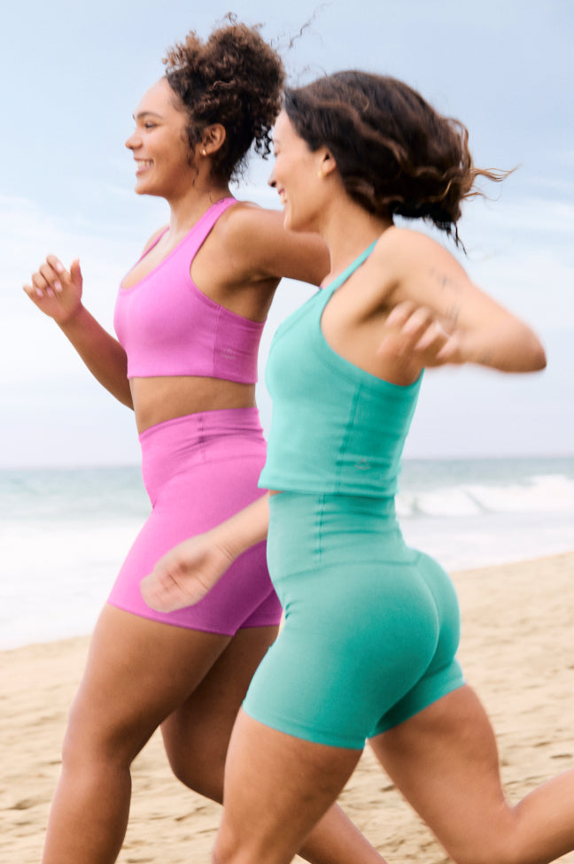 pink bra and pink high-waisted biker shorts. blue cropped tank and blue high-waisted biker shorts. 