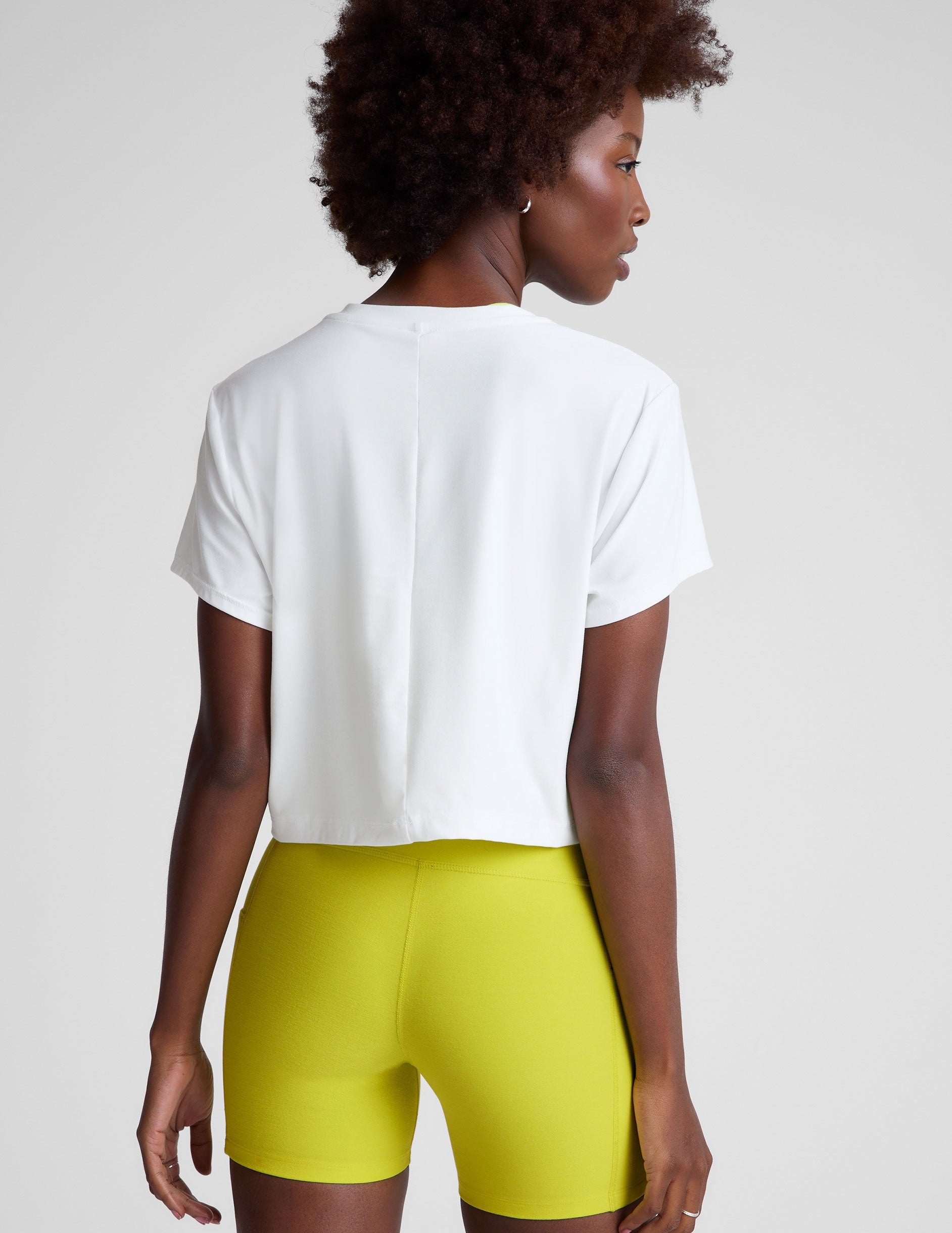 white lightweight loose-fitting cropped tee with a scoop neckline.  