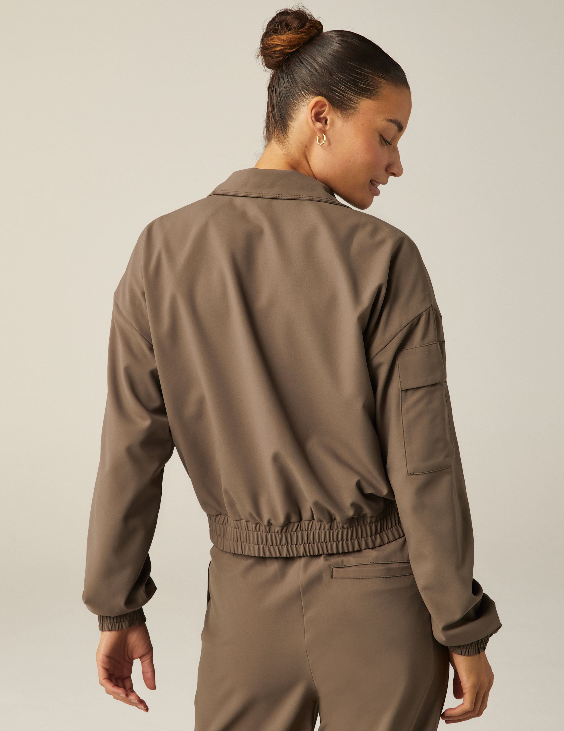 brown zip-up jetstretch woven jacket with a collar and pockets. 