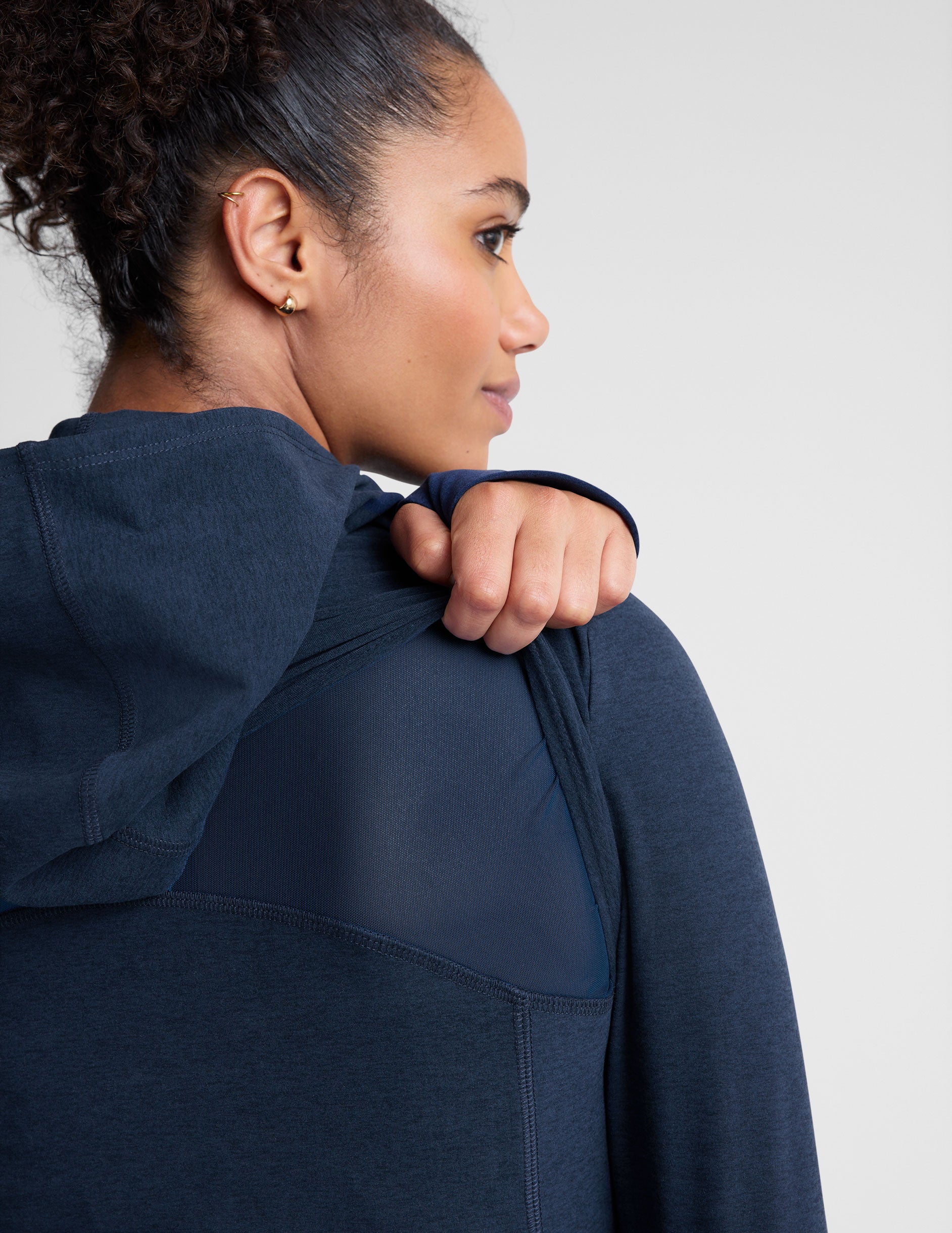 blue zip-up hooded jacket with thumbholes. 