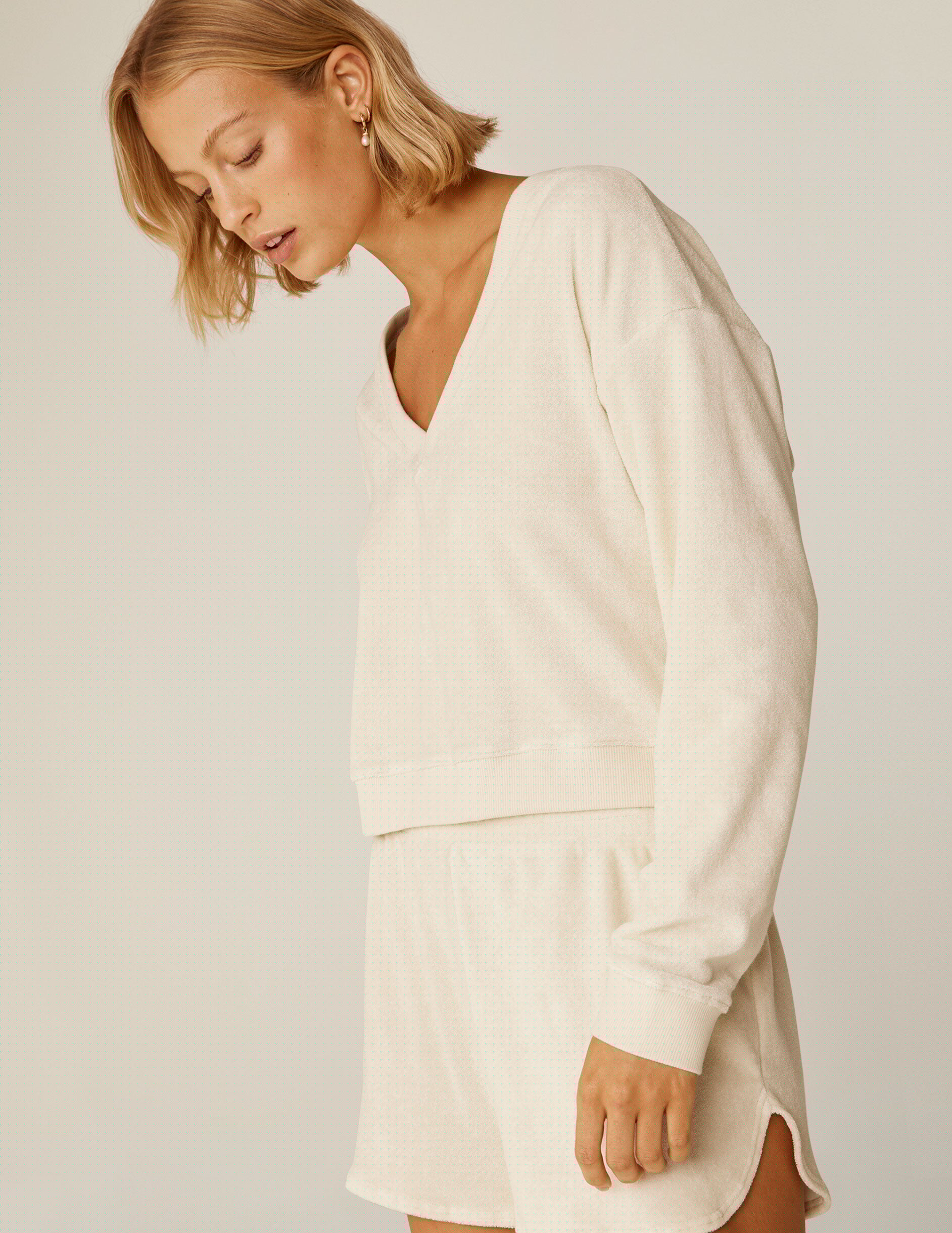 cream colored terry v-neck long sleeve pullover.