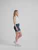 white relaxed fit cropped tank top with a ribbed scooped neckline and ribbed arm holes. 