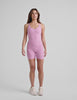 pink waist length, V neckline​ tank top with a self shelf bra and criss-cross strap back detail​. 