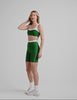 green high-waisted biker shorts with a 7" inseam, waistband colorblock panels​, and contrast piping detail on leg​. 
